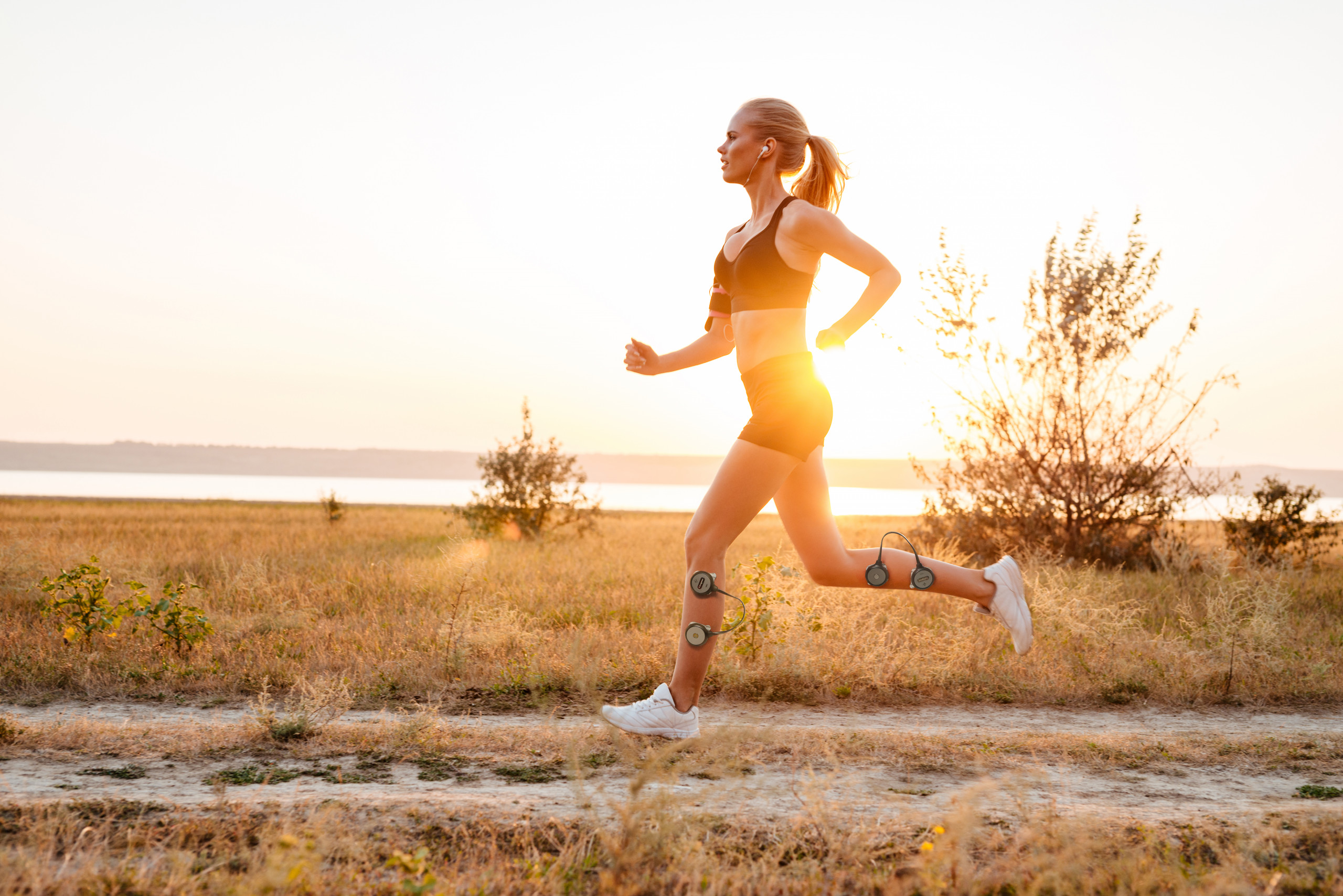 Side view of a beautiful young woman training and running